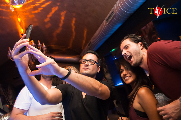 # Twice Club. Selfie in front of the bench of the American bar. Modern happiness.