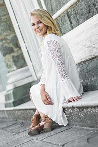 # Ulisse Albiati Photographer: pretty model in a location shooting, sitting on a marble step with a fashion dress. Cathedral of San Miniato al Monte in Florence, Tuscany.