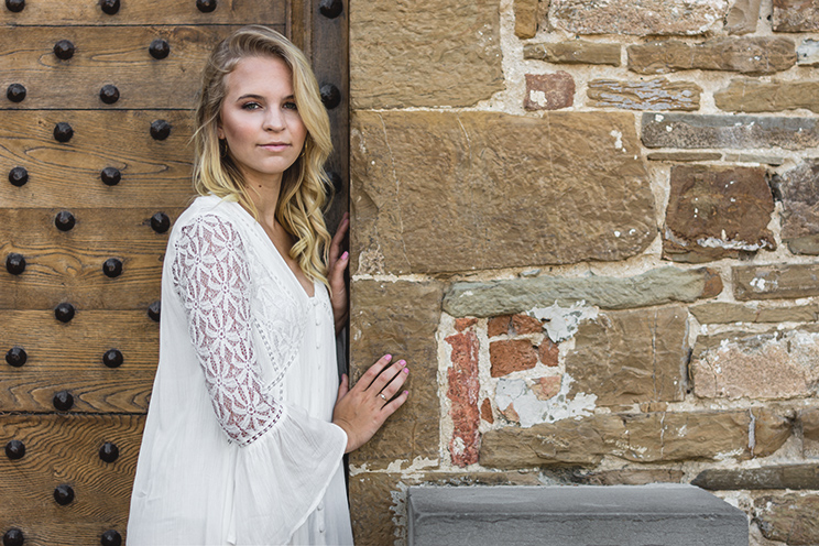 # Ulisse Albiati Photographer: cute model in a location shooting, leaning against a raw wall. Cathedral of San Miniato al Monte in Florence, Tuscany.