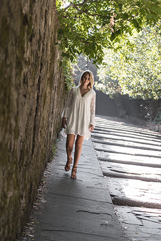 # Ulisse Albiati Photographer: fascinating model in a location shooting, walking down across a picturesque alley. Via del Monte alle Croci below the Piazzale Michelangelo in Florence, Tuscany.