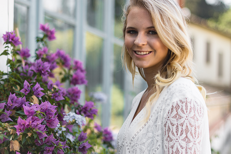 # Ulisse Albiati Photographer: enchanting model in a location shooting, smelling like a purple flower. The Rose Garden below the Piazzale Michelangelo in Florence, Tuscany.