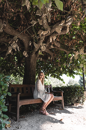 # Ulisse Albiati Photographer: lovely model in a location shooting, relaxing on a bench in the shade. The Rose Garden below the Piazzale Michelangelo in Florence, Tuscany.