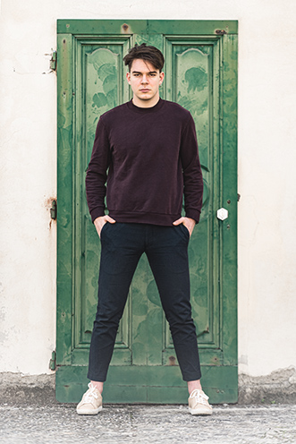 # Ulisse Albiati Photographer: cool model in a location shooting, in front of a light green threshold. The stable of Villa Strozzi al Boschetto in Florence, Tuscany.