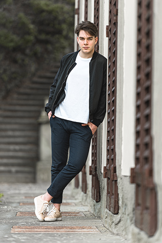 # Ulisse Albiati Photographer: righteous model in a location shooting, leaning against the shutter. The building of Villa Strozzi al Boschetto in Florence, Tuscany.