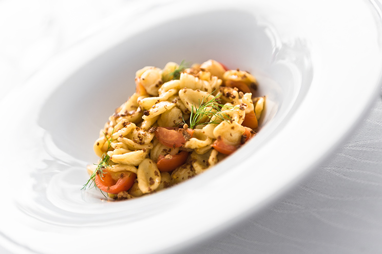 # ulisse albiati food photographer: Southern Italy kitchen specialty: anchovy orecchiette with pachino cherry tomatoes and bread crumbs as first course. Le Pavoniere restaurant in Florence, Tuscany.