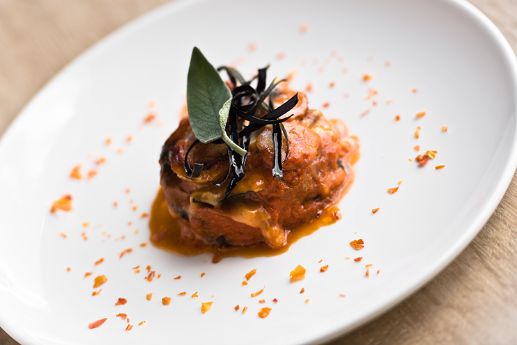 # ulisse albiati food photographer: a fragrant and elegant portion of melanzane alla Parmigiana as second course. Le Pavoniere restaurant in Florence, Tuscany.