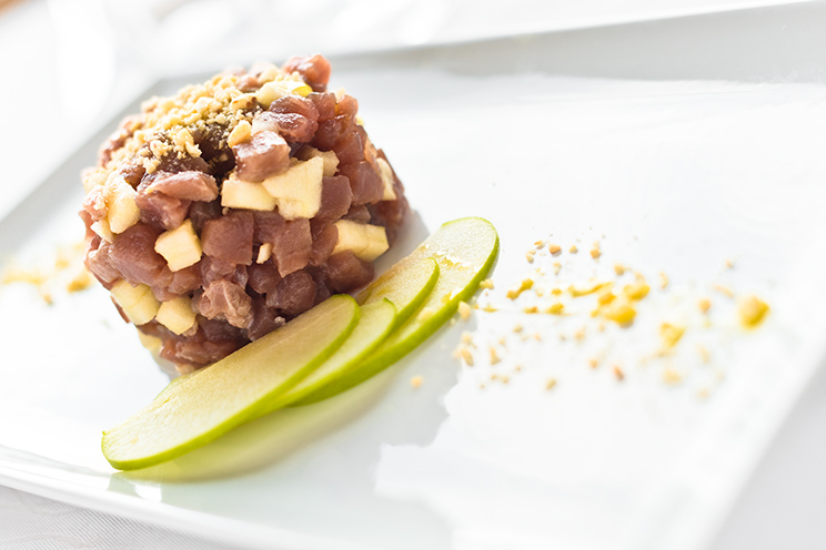 # ulisse albiati food photographer: fresh tuna fish with peanut crumbs, green apple and yellow lemon as second course. Le Pavoniere restaurant in Florence, Tuscany.