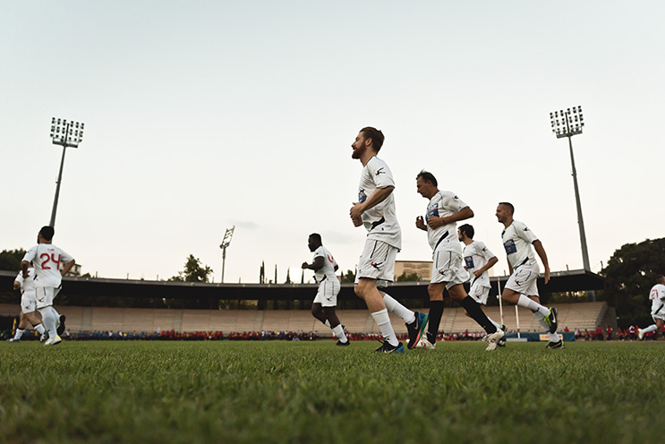 # Ulisse Albiati Sport Photographer: the pitch is delimited with white stripes, which also contribute to the scoring of the two penalty areas, the midfield, and the corner areas. In the center of each minor side of the pitch are the doors.