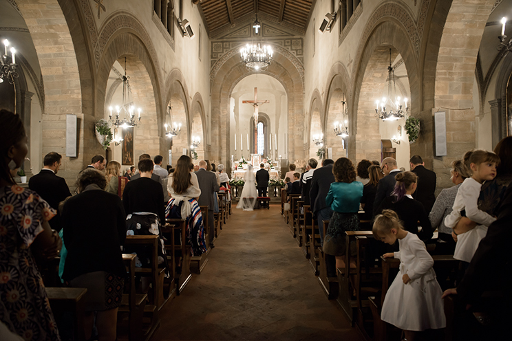 # The married couple inside the church. A mystical forest of guests and columns.