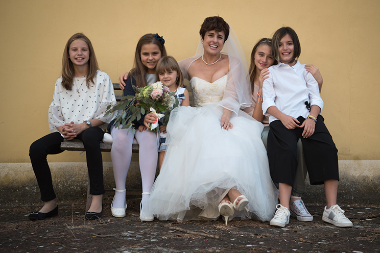 # The bride and all her fresh friends on an old original bench.