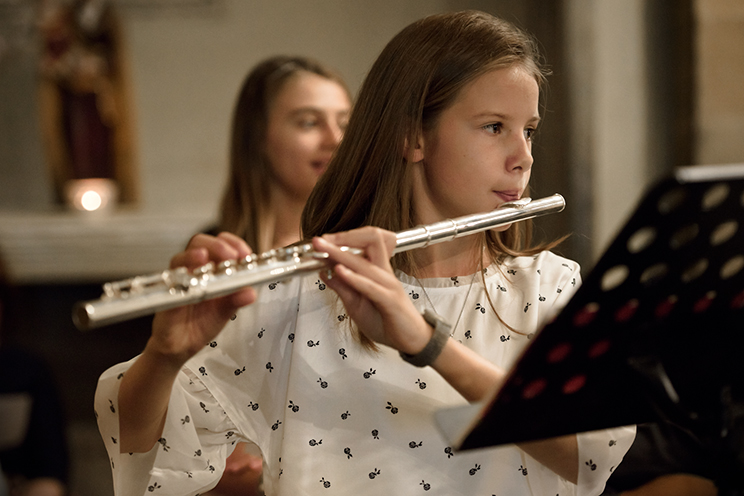 # A sweet young flutist does not play the Canon and Gigue for 3 violins and basso continuo by Johann Pachelbel.